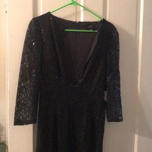 Black sequin sheath gown. Plunging neckline